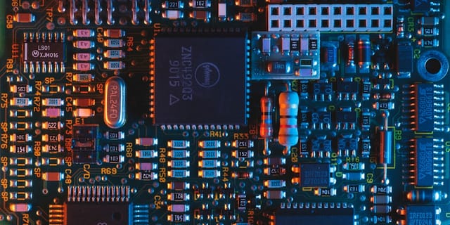 Close-up of DDR5 RAM modules and an M.2 NVMe SSD mounted on a modern motherboard.