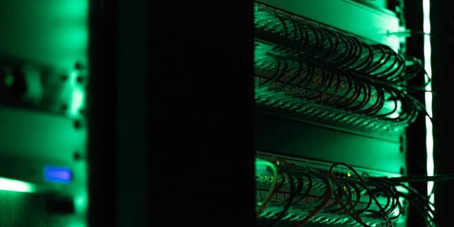 Rows of server racks in a data center with cooling cables