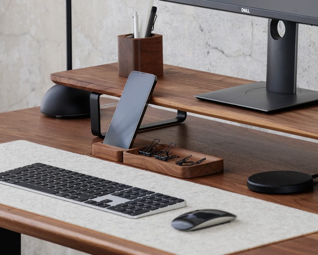A modern smartphone on a desk with a code editor open, displaying an AI agent interface.
